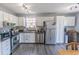 Well-lit kitchen with stainless steel appliances, white cabinets, and dark countertops at 740 Springmill Dr, Mooresville, IN 46158