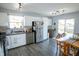 Well-equipped kitchen with stainless steel appliances, modern countertops, and an adjacent dining area at 740 Springmill Dr, Mooresville, IN 46158
