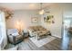 Cozy living room with hardwood floors, neutral paint, ceiling fan, and a comfortable seating arrangement at 740 Springmill Dr, Mooresville, IN 46158