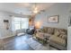 Bright living room featuring hardwood floors, a large window, and comfortable seating at 740 Springmill Dr, Mooresville, IN 46158
