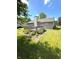 Spacious backyard featuring a wooden deck, stone patio, and lush green lawn at 8425 Brook Pointe Ct, Indianapolis, IN 46234