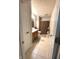Hallway bathroom with tiled floors, wood vanity and shower with curtain at 8425 Brook Pointe Ct, Indianapolis, IN 46234