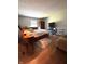 Bedroom featuring wood floors, neutral walls, a ceiling fan, and built-in furniture at 8425 Brook Pointe Ct, Indianapolis, IN 46234