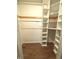 Walk-in closet with wooden floors and modular shelving at 8425 Brook Pointe Ct, Indianapolis, IN 46234