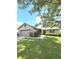 Single story home features a manicured lawn, updated siding, and mature landscaping at 8425 Brook Pointe Ct, Indianapolis, IN 46234