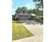 Charming single-story home with a two car garage, a well-kept lawn, and mature trees at 8425 Brook Pointe Ct, Indianapolis, IN 46234