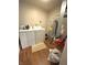 Utility room equipped with a washer, dryer, and water heater on wood-look flooring at 8425 Brook Pointe Ct, Indianapolis, IN 46234