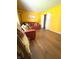 Bright living room with hardwood floors, yellow walls, red sofa and chair at 8425 Brook Pointe Ct, Indianapolis, IN 46234