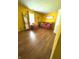 Inviting living room features hardwood floors, bright yellow walls, and cozy furniture at 8425 Brook Pointe Ct, Indianapolis, IN 46234