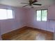 Bedroom with hardwood floors, pink walls and two windows at 9138 E 18Th St, Indianapolis, IN 46229