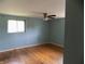 Bedroom with hardwood floors, light blue walls, ceiling fan and a window at 9138 E 18Th St, Indianapolis, IN 46229