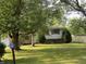 Charming home featuring a well-maintained lawn and mature trees framing the front yard at 9138 E 18Th St, Indianapolis, IN 46229