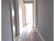 Hallway with grey walls and modern wood-look flooring at 9138 E 18Th St, Indianapolis, IN 46229