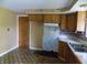 Outdated kitchen that needs renovation with dated cabinets and flooring at 9138 E 18Th St, Indianapolis, IN 46229