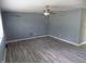 Bright living room with new grey wood-look flooring and a ceiling fan at 9138 E 18Th St, Indianapolis, IN 46229