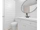 Stylish bathroom features modern fixtures and a white vanity, plus white plank walls and flooring at 9319 Rochelle Dr, Indianapolis, IN 46235