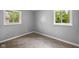 Corner bedroom featuring two windows providing natural light and neutral carpet at 9319 Rochelle Dr, Indianapolis, IN 46235
