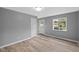 Bright bedroom with neutral walls, new floors, white trim, and a view to the neighborhood at 9319 Rochelle Dr, Indianapolis, IN 46235