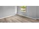Bright bedroom with neutral walls, new floors, white trim, and a large window at 9319 Rochelle Dr, Indianapolis, IN 46235