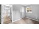 Light-filled bedroom with neutral carpet, closet, and a window overlooking the backyard at 9319 Rochelle Dr, Indianapolis, IN 46235