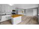 Spacious open kitchen featuring white cabinets, new countertops, stainless steel appliances, and a wood island at 9319 Rochelle Dr, Indianapolis, IN 46235