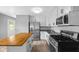 Bright kitchen with stainless appliances, granite counters, a center island, and a door to the backyard at 9319 Rochelle Dr, Indianapolis, IN 46235