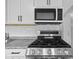Updated kitchen features stainless steel appliances, granite counters, and white cabinets at 9319 Rochelle Dr, Indianapolis, IN 46235