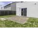 View of the backyard with the sliding glass door and a patio area and some grass at 9665 Gull Lake Dr, Indianapolis, IN 46239