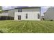 View of the backyard with the sliding glass door and a long green lawn at 9665 Gull Lake Dr, Indianapolis, IN 46239