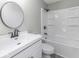 This bathroom has a large mirror and full bath and shower with white cabinets and counters at 9665 Gull Lake Dr, Indianapolis, IN 46239