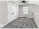 Upstairs bedroom with ceiling fan, double doors, and a window at 9665 Gull Lake Dr, Indianapolis, IN 46239