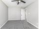 This is a bedroom with gray walls and gray carpet with a ceiling fan and a white door at 9665 Gull Lake Dr, Indianapolis, IN 46239