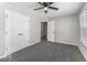 This is a bedroom with gray walls and gray carpet with a ceiling fan and a closet at 9665 Gull Lake Dr, Indianapolis, IN 46239