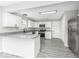 Modern kitchen featuring white cabinets, stainless steel appliances, and granite countertops with durable flooring at 9665 Gull Lake Dr, Indianapolis, IN 46239