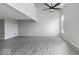 Spacious living room with soaring ceilings, modern ceiling fan, and durable gray vinyl flooring at 9665 Gull Lake Dr, Indianapolis, IN 46239