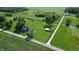 Aerial view of two homes on large, beautiful lots, framed by lush green fields and towering trees at 9721 S 100 E, Pendleton, IN 46064