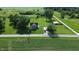 Aerial view of a charming property with a gray house, matching barn, and surrounded by picturesque farmland at 9721 S 100 E, Pendleton, IN 46064