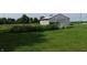 Exterior view of a barn with silver metal siding and overgrown garden in front at 9721 S 100 E, Pendleton, IN 46064