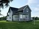 Charming two-story home with blue siding, black roof, and a well-maintained lawn at 9721 S 100 E, Pendleton, IN 46064