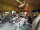 Interior view of a garage filled with lawn care items, tools, and recreational vehicles at 9721 S 100 E, Pendleton, IN 46064