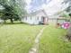 Expansive backyard featuring a well-maintained lawn and white siding home at 1002 S Fleming St, Indianapolis, IN 46241