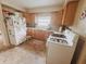 Functional kitchen with updated appliances, wood cabinets, and ample counter space at 1002 S Fleming St, Indianapolis, IN 46241
