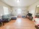 Inviting living room with hardwood floors, sofa, media center and view to dining area at 1002 S Fleming St, Indianapolis, IN 46241