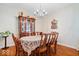 Elegant dining room with hardwood floors, a vintage china cabinet, and a chandelier, perfect for formal dinners at 10381 Beaver Ridge Dr, Fishers, IN 46037