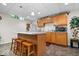 Basement kitchenette with island, bar stools, and oak cabinets at 10381 Beaver Ridge Dr, Fishers, IN 46037