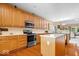 Modern kitchen with stainless steel appliances, wooden cabinets, hardwood floors, and a functional center island at 10381 Beaver Ridge Dr, Fishers, IN 46037