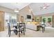 Bright living room with vaulted ceilings, a fireplace, and a dining area, perfect for entertaining guests at 10381 Beaver Ridge Dr, Fishers, IN 46037