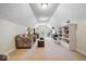 Spacious living room with neutral carpeting, seating, and a built-in bookshelf at 10381 Beaver Ridge Dr, Fishers, IN 46037