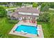 Aerial view of a home with a pool, outdoor patio, and landscaped yard, perfect for entertaining at 10594 Geist Rd, Fishers, IN 46037