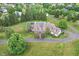 Stunning aerial view of a large home with a pool, lush landscaping, and a circular driveway at 10594 Geist Rd, Fishers, IN 46037